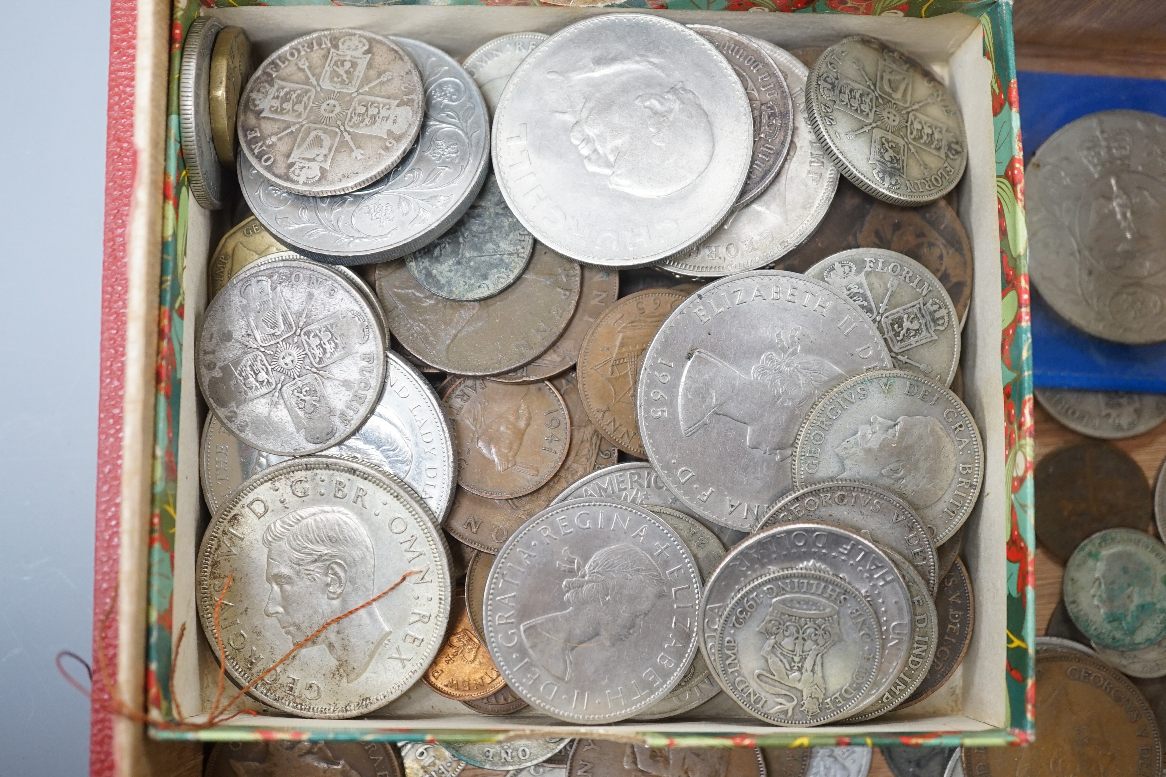 A collection of coins including a Victoria crown and two florins